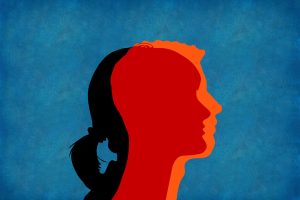 a woman's silhouette overlapping with a man's silhouette against a blue background