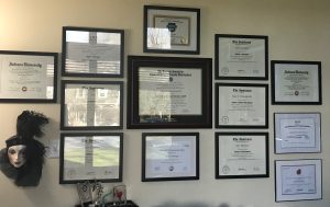 a wall full of 13 individually framed certificates