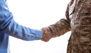 Military and civilian shaking hands