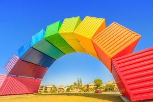 Fremantle, Australia - Jan 7, 2018: Fremantle travel welcome. Rainbow Sea Container in Fremantle Port near Perth, Western Australia. Homosexuality and hope concept. Blue sky. Copy space.